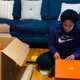 Ajón Crump checks a box of Nikes intended for shipping.